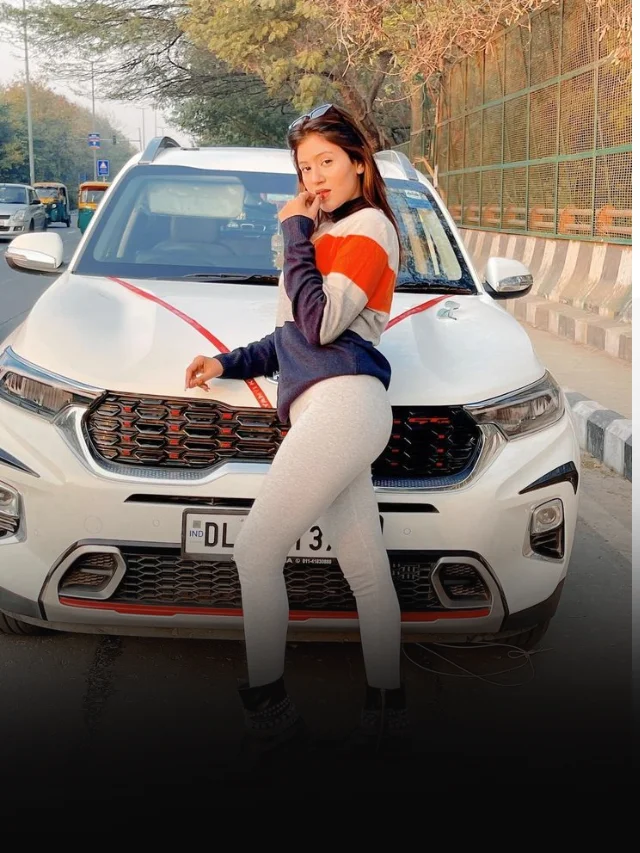 Anjali Arora front of a car